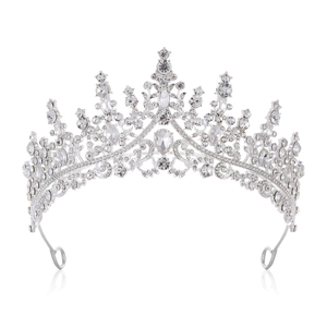 Macro detail of a silver wedding crown featuring intricate crystal and rhinestone settings