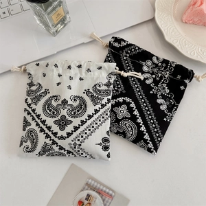 Detail of drawstring pouches with paisley patterns and decorative scalloped edges