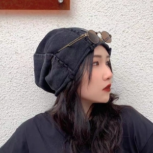 Side view of trendy black washed denim slouchy beanie for street style fashion look