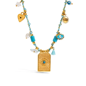 Vintage turquoise beaded necklace with gold evil eye and sun charms on a blue cord