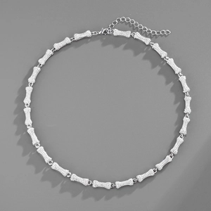 Macro detail of silver bone pendant necklace with iced-out crystals and lobster clasp