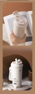 Close-up of a double-wall ceramic liner coffee mug with dual lid and woven handle