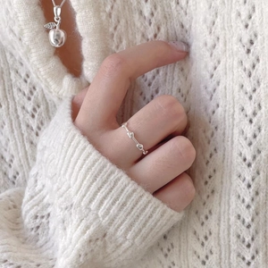 Minimalist 925 sterling silver heart ring worn by model with matching apple necklace