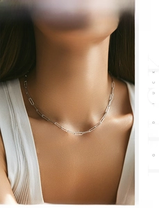 Detail view of S925 sterling silver paperclip chain necklace with shimmering hammered texture