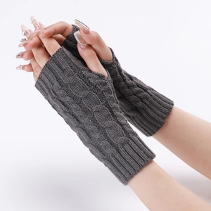 Detail of grey cable knit fingerless gloves showing texture and arm sleeve design