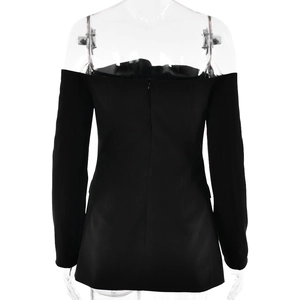Detail view of black off-shoulder long sleeve dress with back zipper on transparent mannequin