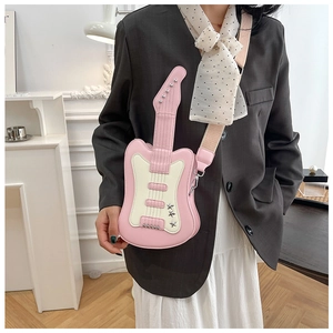 Detail of pink and beige guitar-shaped crossbody bag with star rivets and wide strap
