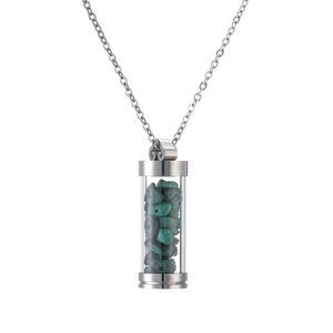 Detail of silver perfume bottle pendant necklace filled with green crushed stones