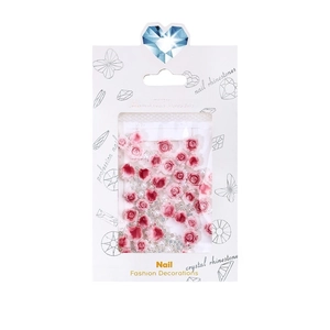 Mix of resin rose nail charms with pearls and crystals in a white retail display box