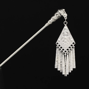 Detail of silver Miao hair stick with intricate filigree and delicate fringe tassels
