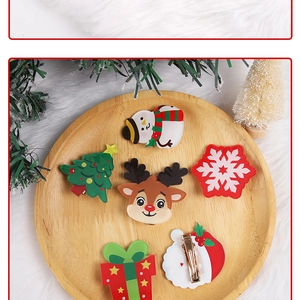 Close-up of a 6-piece Christmas hair clip set with acrylic Santa and reindeer designs