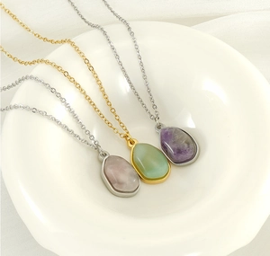 Detailed view of three natural stone teardrop pendants on gold and silver chains