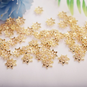 Macro detail of 14K gold-plated star flower bead caps for DIY jewelry making