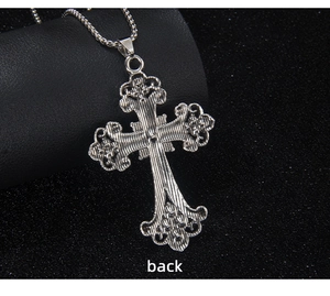 Detail view of the silver cross necklace back with vintage floral hollow pattern