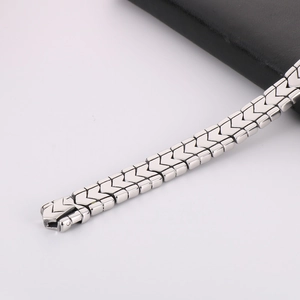 Detailed view of polished stainless steel V-shaped chain link bracelet with mirror finish