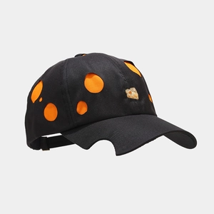 Detail view of contrast baseball cap with Meteor cut-outs and circular orange patterns