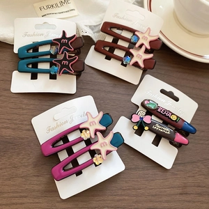 Close-up of star acrylic hair clips on wood background with lace and decorative cards