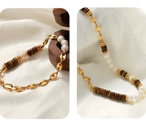 Detailed view of tiger eye stone and pearl necklace with golden coffee bean link chain