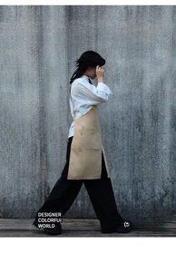 Workwear khaki canvas apron featuring a split hem and large pockets for extra mobility