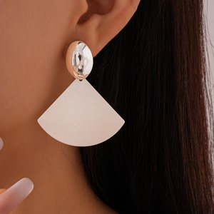 Detail shot of a silver oval stud with a light pink fan-shaped pendant on a female model