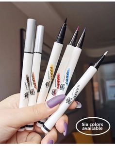 Detail of six colorful liquid eyeliners held in hand featuring ultra-fine brush tips