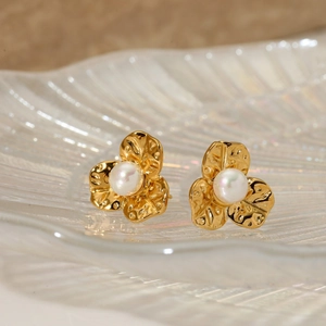Macro shot of 316L stainless steel flower stud earrings with elegant pearl centers