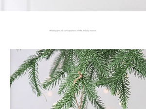Detail of faux pine branch Christmas decor with natural twine rope and festive holiday greeting
