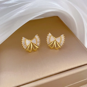 Titanium steel bow stud earrings with white shell and zircons on champagne satin box