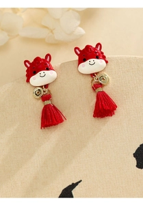 Detailed macro view of red enamel horse earrings with elegant gold coins and silk tassels