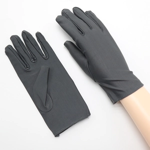 Close-up of dark grey spandex gloves with elastic material and overlock wrist stitching