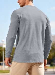 Detailed back view of men's grey waffle knit Henley shirt in a natural outdoor setting