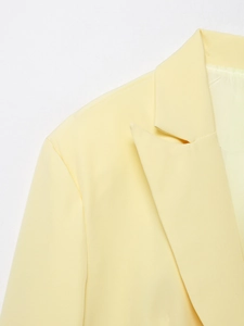 Close-up of Notch Lapel and Shoulder Detail on a Pale Yellow Tailored Women Blazer Jacket