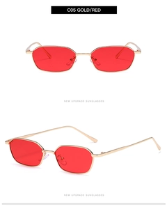 Detail view of small polygonal gold metal sunglasses with vibrant red sea-style lenses