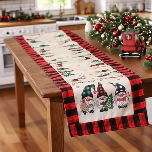 Linen Christmas table runner with gnomes and reindeer on a rustic wooden table