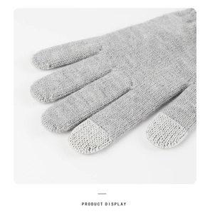 Close-up of grey knitted gloves with touchscreen-compatible fingertips for winter