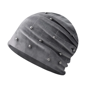 Detail of dark grey slouchy beanie featuring soft chenille fabric and silver bead accents