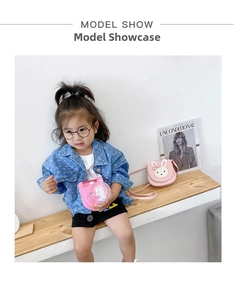 Detail showing a pink rabbit-ear crossbody bag and a blue denim jacket on a child