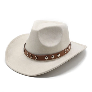Close-up of beige suede cowboy hat with brown leather band and silver metal studs
