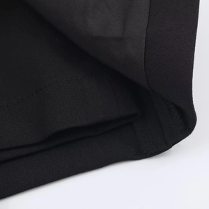 Macro shot of double-stitched reinforced corners on black fine-twill fabric skorts
