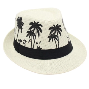 Detail of cream straw fedora hat featuring black coconut tree embroidery and ribbon