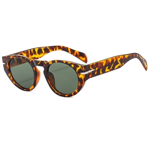 Retro round tortoise shell sunglasses with dark green lenses and silver arrow hinge