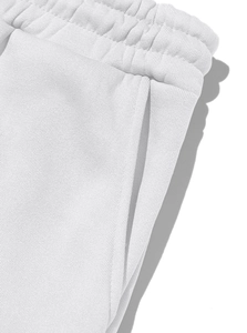 Detail of the elastic waistband and side pocket on white fleece jogging trousers