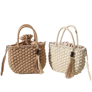 Handmade woven straw tote bags in beige and brown with wooden beads and tassel details