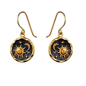Detailed close-up of bohemian sun and moon drop earrings with antique gold relief finish