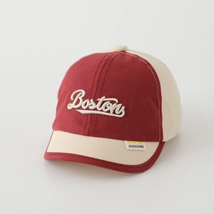 Detail view of cotton baseball cap showing red and cream contrast panels and Boston embroidery