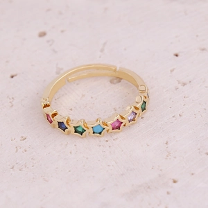 Macro shot of gold adjustable ring featuring seven colorful zircon star-shaped stones