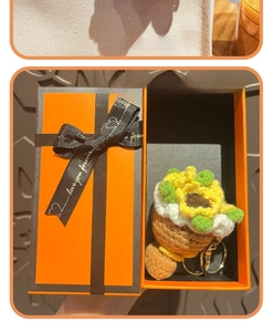 Handcrafted crochet sunflower keychain presented in a premium orange gift box with gold ring
