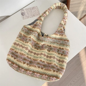 Detail view of ethnic plush tote bag featuring soft colored stripes and gingham lining