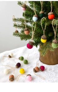 Detail of wool felt acorn Christmas ornaments with natural caps and hanging ropes