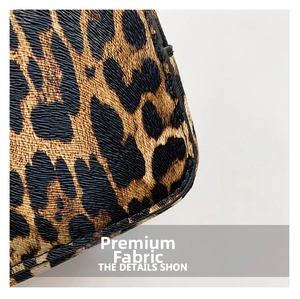 Close-up of leopard print texture and precise stitching on the large shoulder bag